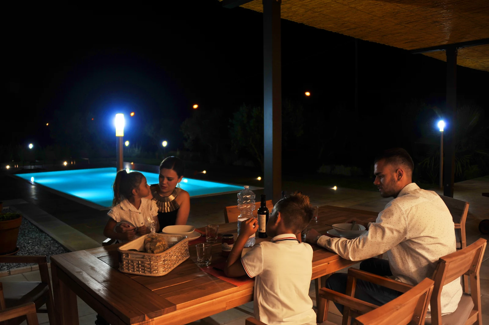 Dinner outdoors by the pool at night